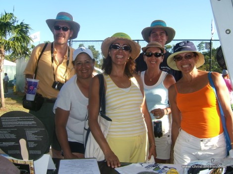 Fun group of people visiting International Christian Tennis Association exhibitor's booth.